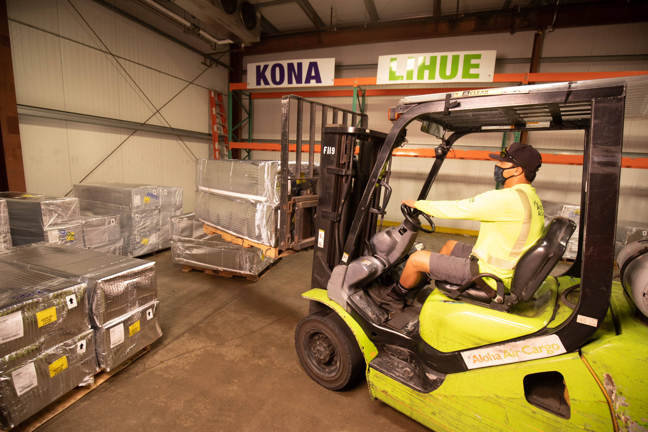 Aloha Air Cargo employee operating a forklift.