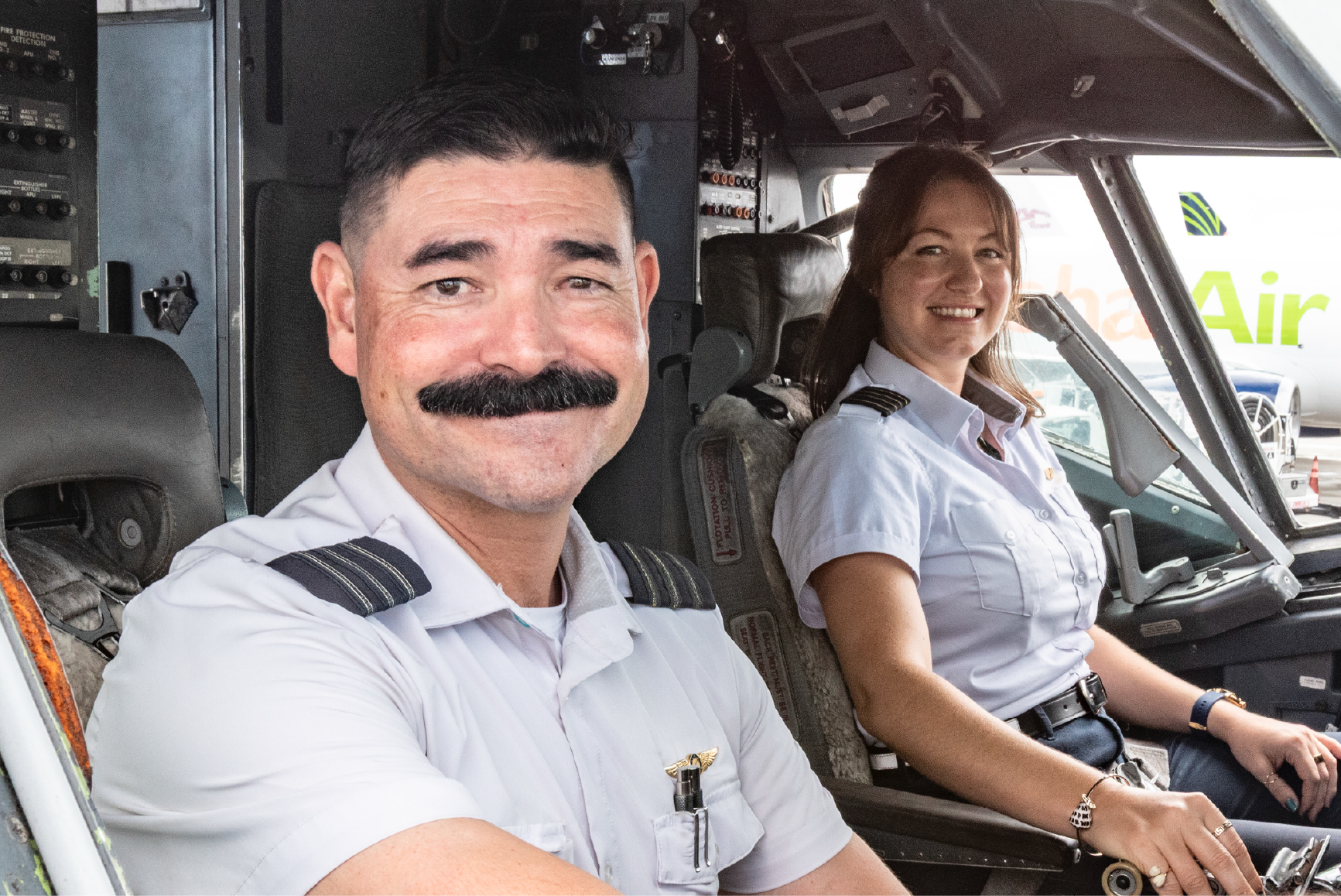 Photo of an airline mechanic with a flashlight inspecting a plane. Photo of an airline mechanic with a flashlight inspecting a plane.